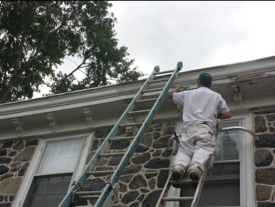 Applying a fresh coat of paint to the exterior flashing - Delaware County PA